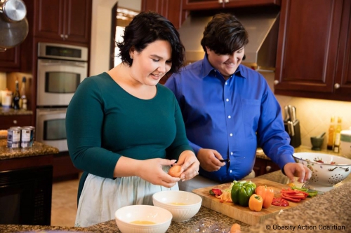 Overweight couple cooking healthy food