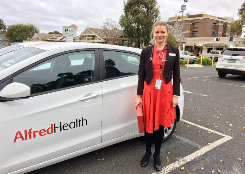 Dr Margot Lodge standing next to Alfred Health car 