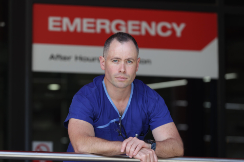 Alfred Health trauma deputy director Dr Simon Hendel standing in front of Emergency sign at The Alfred