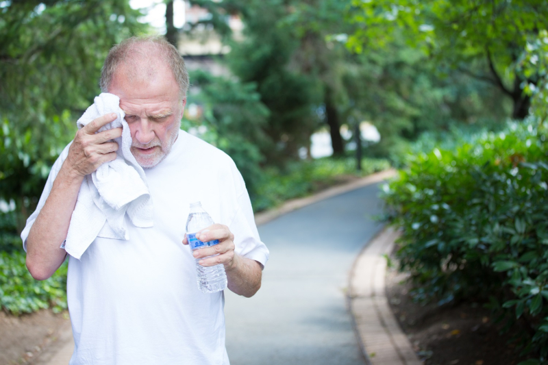 Senior man exercising with drink bottle