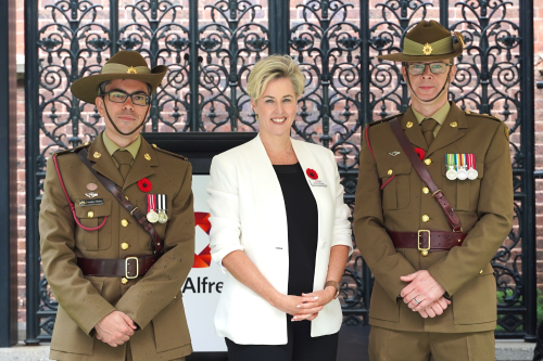 Major Jonathan Begley stands with Lieutenant Colonel Charles Pilgrim, with Acting CEO Simone Alexander in the middle at the service